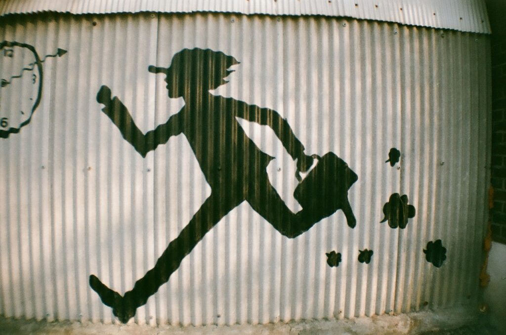 Shadow of a man with a briefcase running