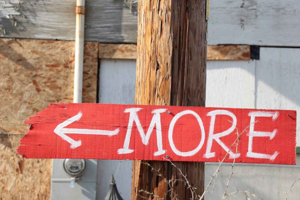 A sign on a post which says "More"