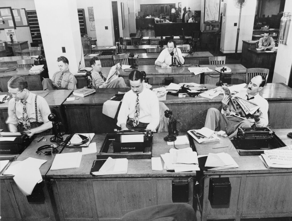 Reporters in an old newspaper office.