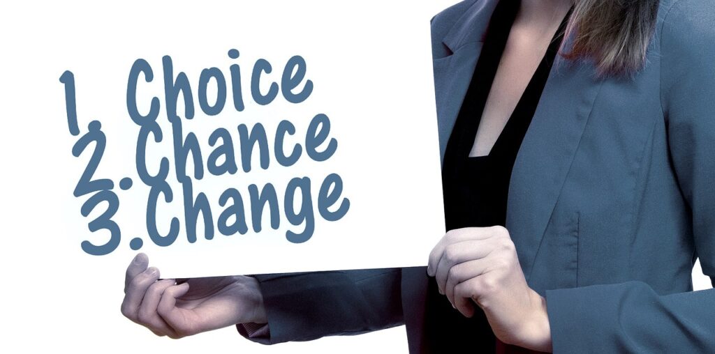 Woman holding a sign saying Choice, Chance, Change.