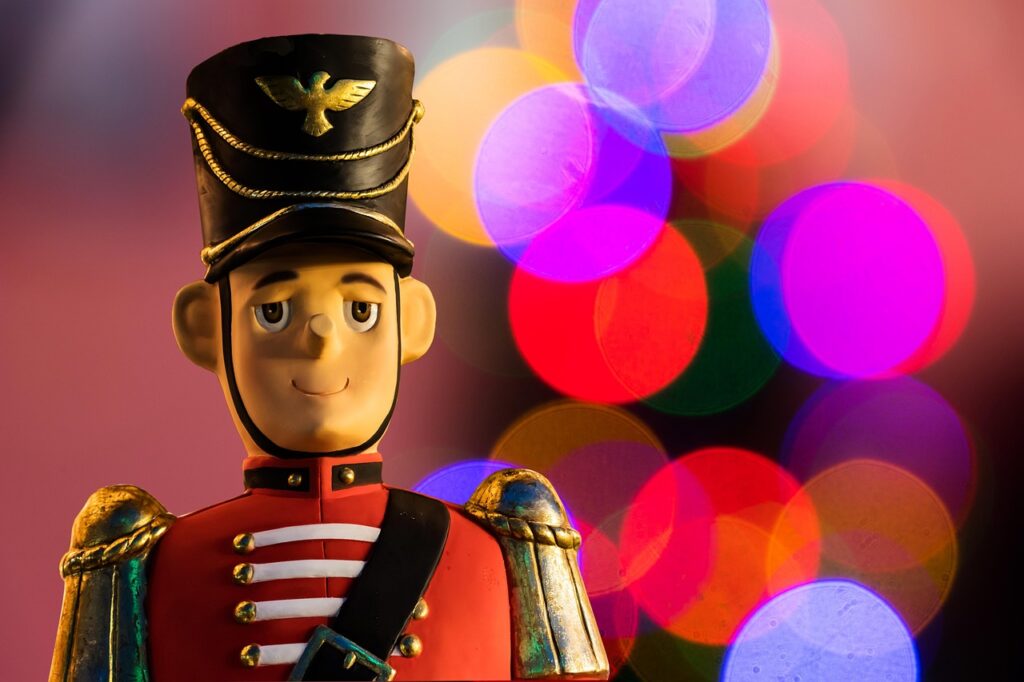 A toy nutcracker with colorful circles in the background.