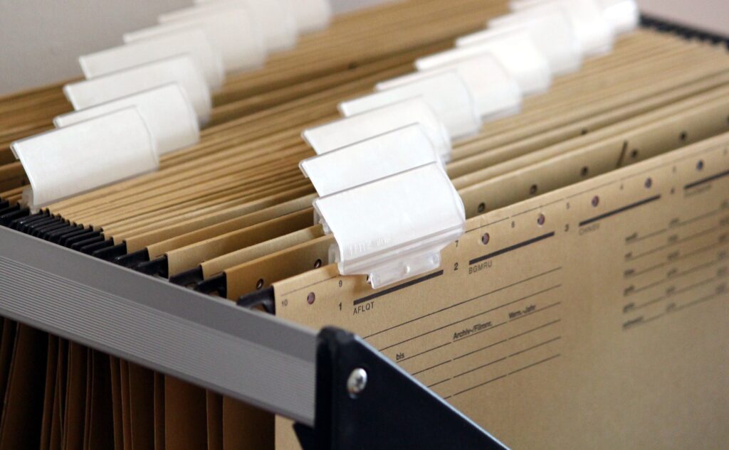 Hanging file folders with blank labels.