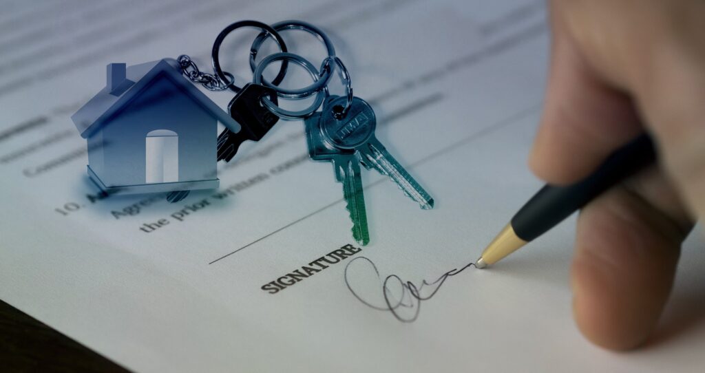 House keys on a contract being signed.