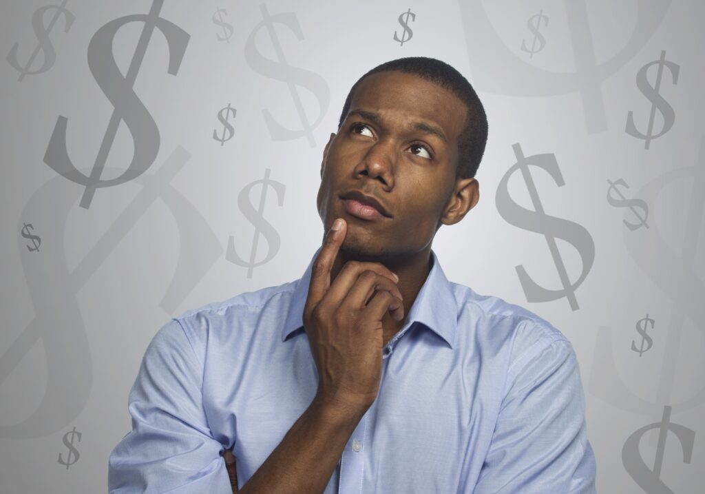 Man thinking with dollar signs in the background.