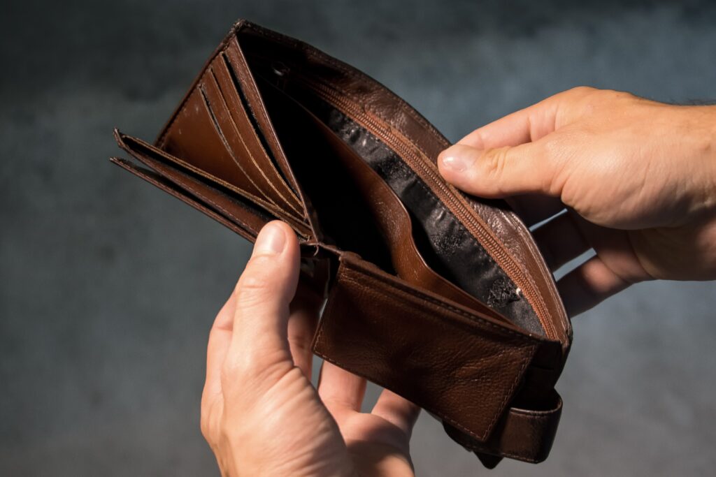 Someone opening an empty wallet.